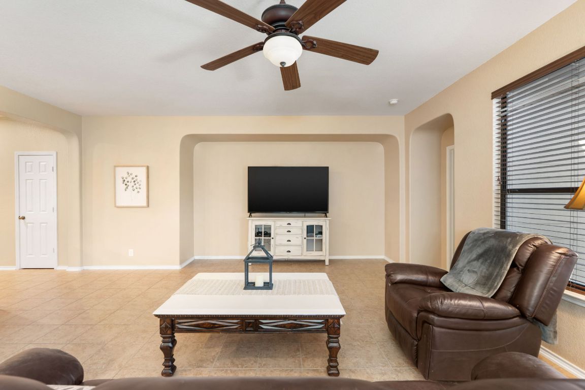 366 Matthews Lane Kyle, TX 78640 - Photo 11 of 25 a living room with furniture and a flat screen tv