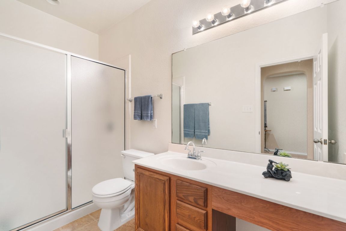 366 Matthews Lane Kyle, TX 78640 - Photo 17 of 25 a bathroom with a sink and a mirror