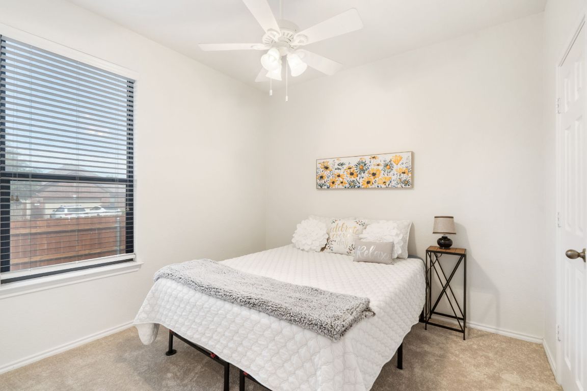 366 Matthews Lane Kyle, TX 78640 - Photo 21 of 25 a bedroom with a large bed and a window