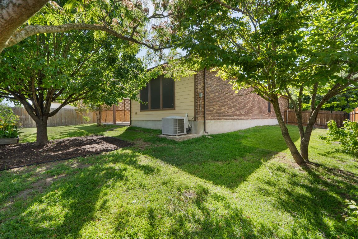 366 Matthews Lane Kyle, TX 78640 - Photo 25 of 25 a view of a backyard with large trees