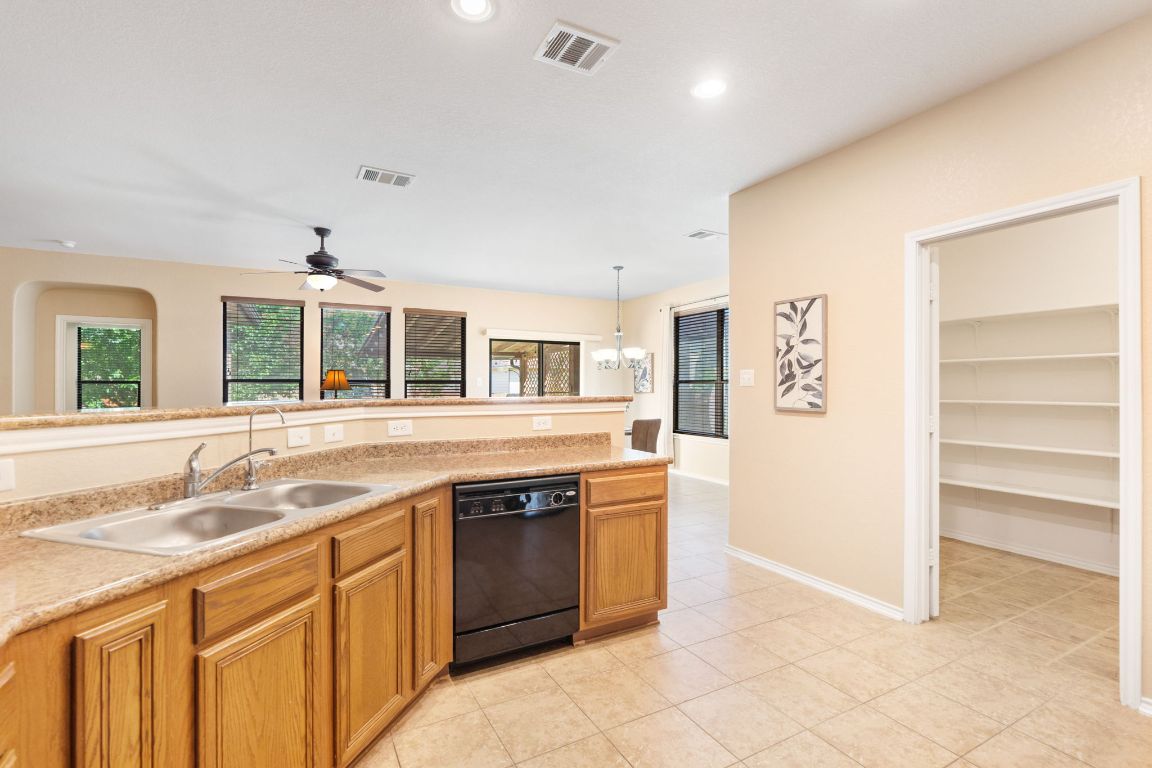 366 Matthews Lane Kyle, TX 78640 - Photo 10 of 25 a kitchen with a sink stove and cabinets