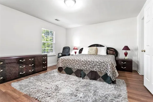 a bedroom with a bed and a dresser