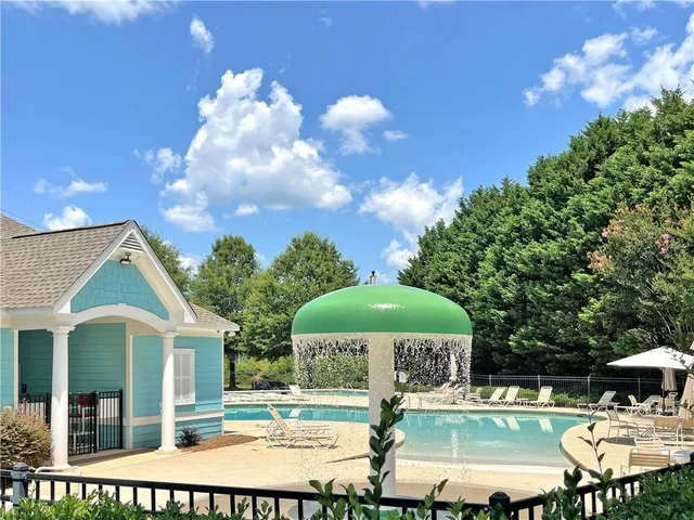 a view of a patio with table and chairs under an umbrella