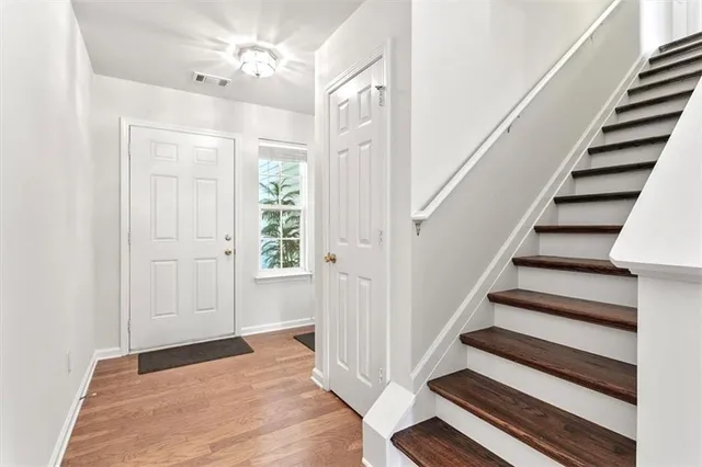 a view of entryway with wooden floor and stairs
