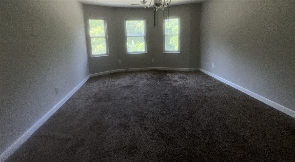 115 Mountain Springs Road West Union, SC 29696 - Photo 8 of 17 Generous room proportions highlight a classic bay window alcove framing green outdoor views.