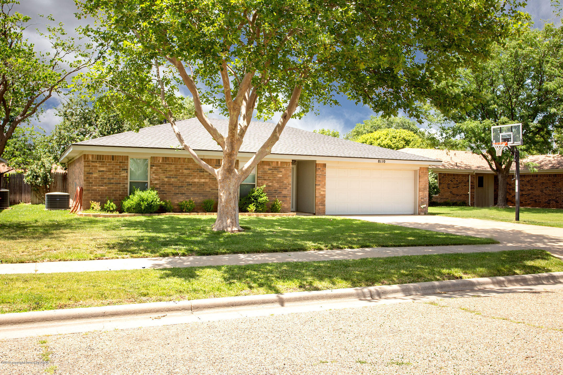 8110 Santa Fe Trail Amarillo, TX 79110 - Photo 2 of 25 a view of a house with a large tree and a yard