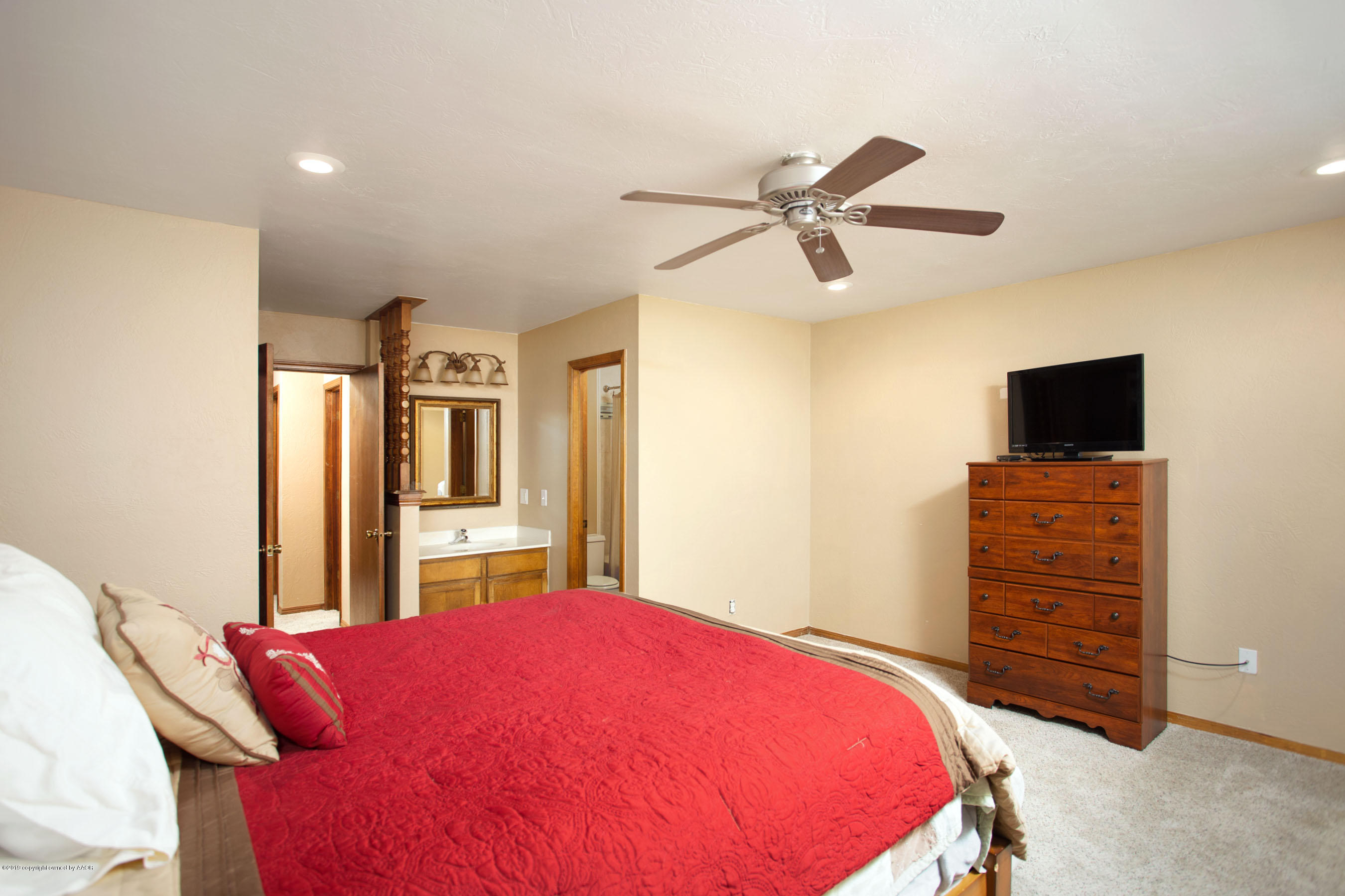 8110 Santa Fe Trail Amarillo, TX 79110 - Photo 13 of 25 a bedroom with a bed and a flat screen tv