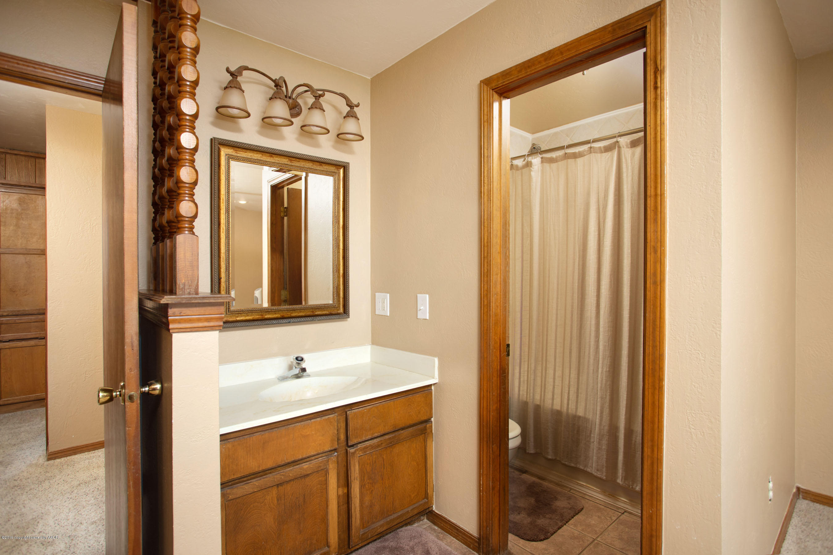 8110 Santa Fe Trail Amarillo, TX 79110 - Photo 15 of 25 a bathroom with a sink a toilet and shower