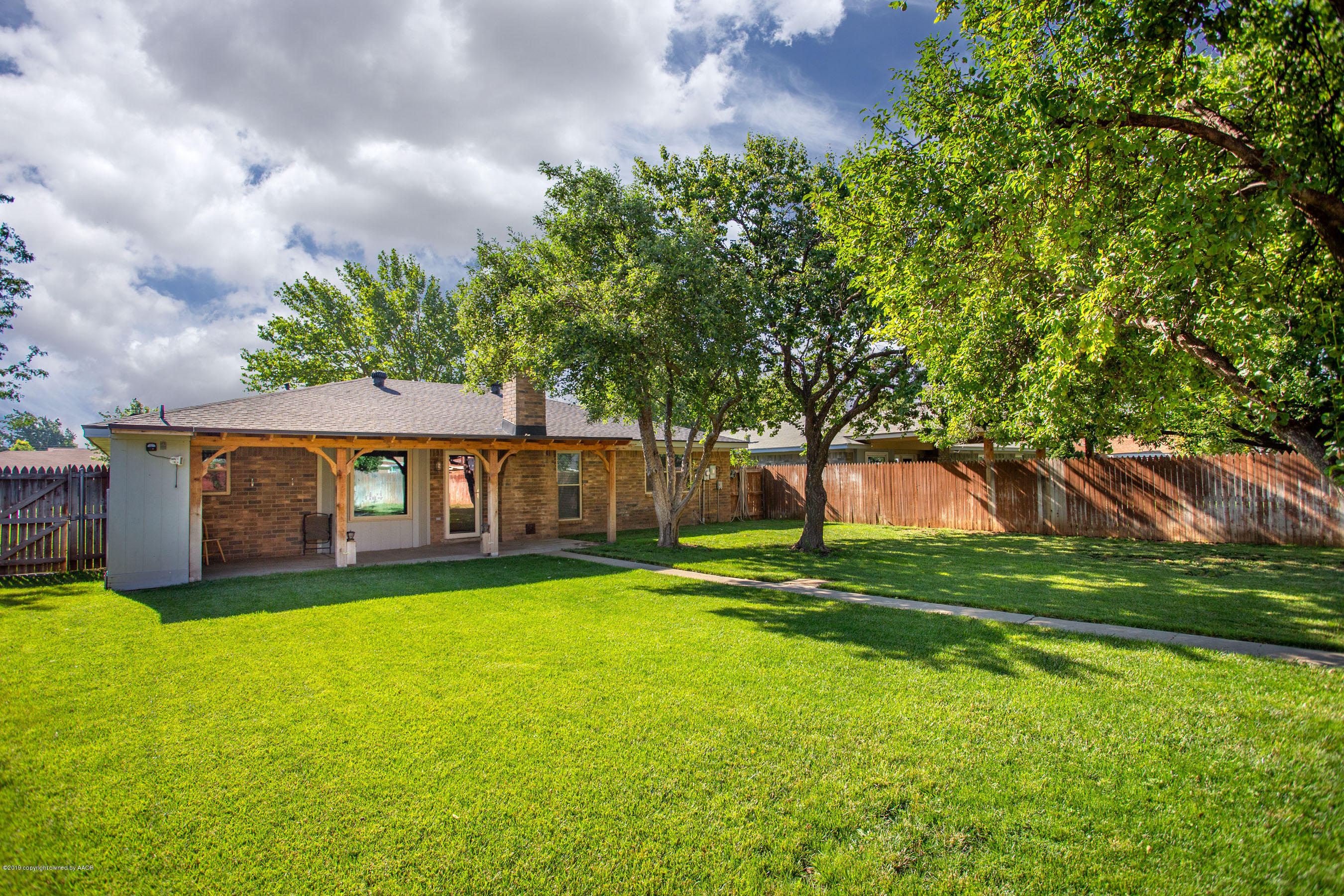 8110 Santa Fe Trail Amarillo, TX 79110 - Photo 23 of 25 a view of a big yard next to a house with large trees