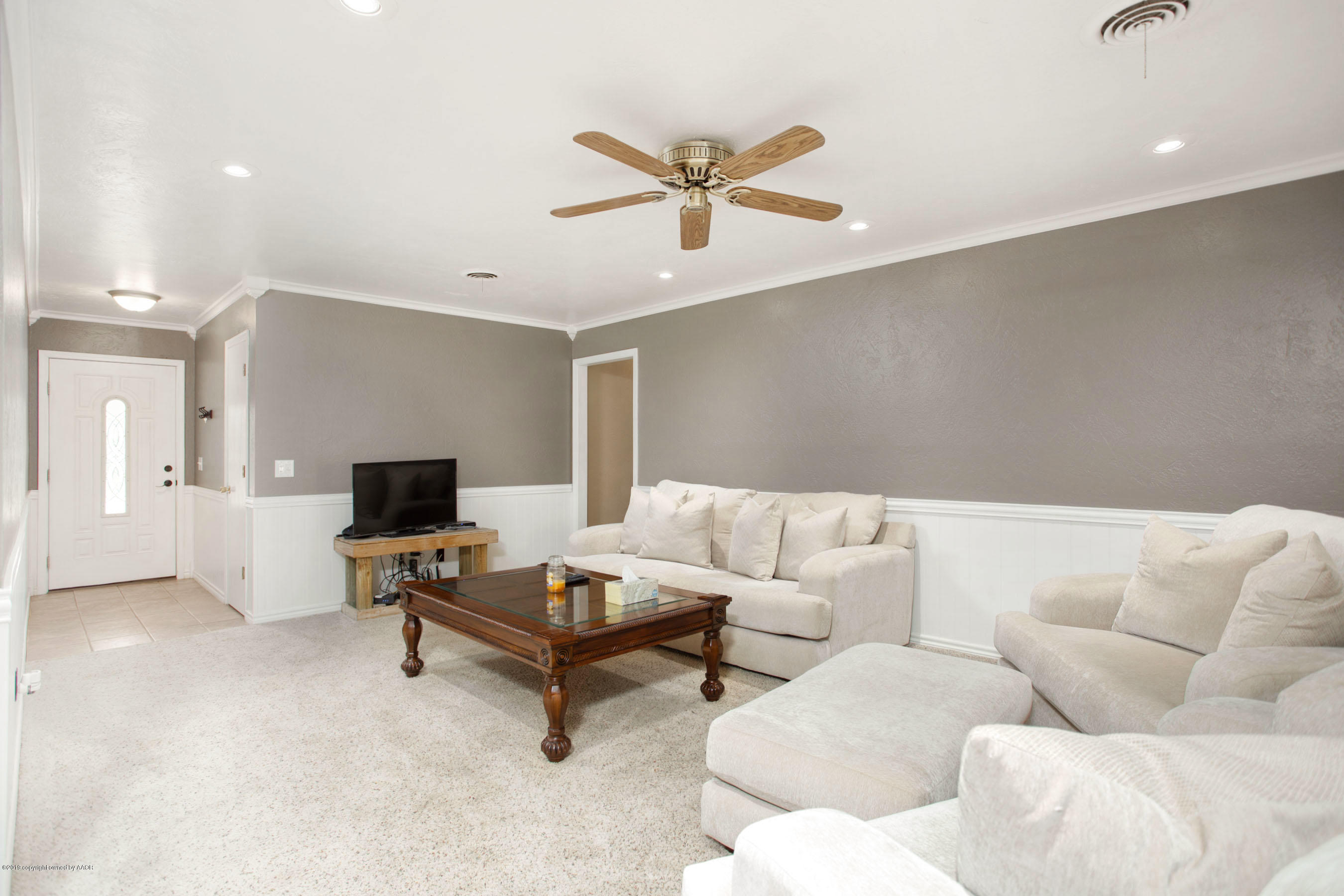 8110 Santa Fe Trail Amarillo, TX 79110 - Photo 6 of 25 a living room with furniture and a flat screen tv with rug
