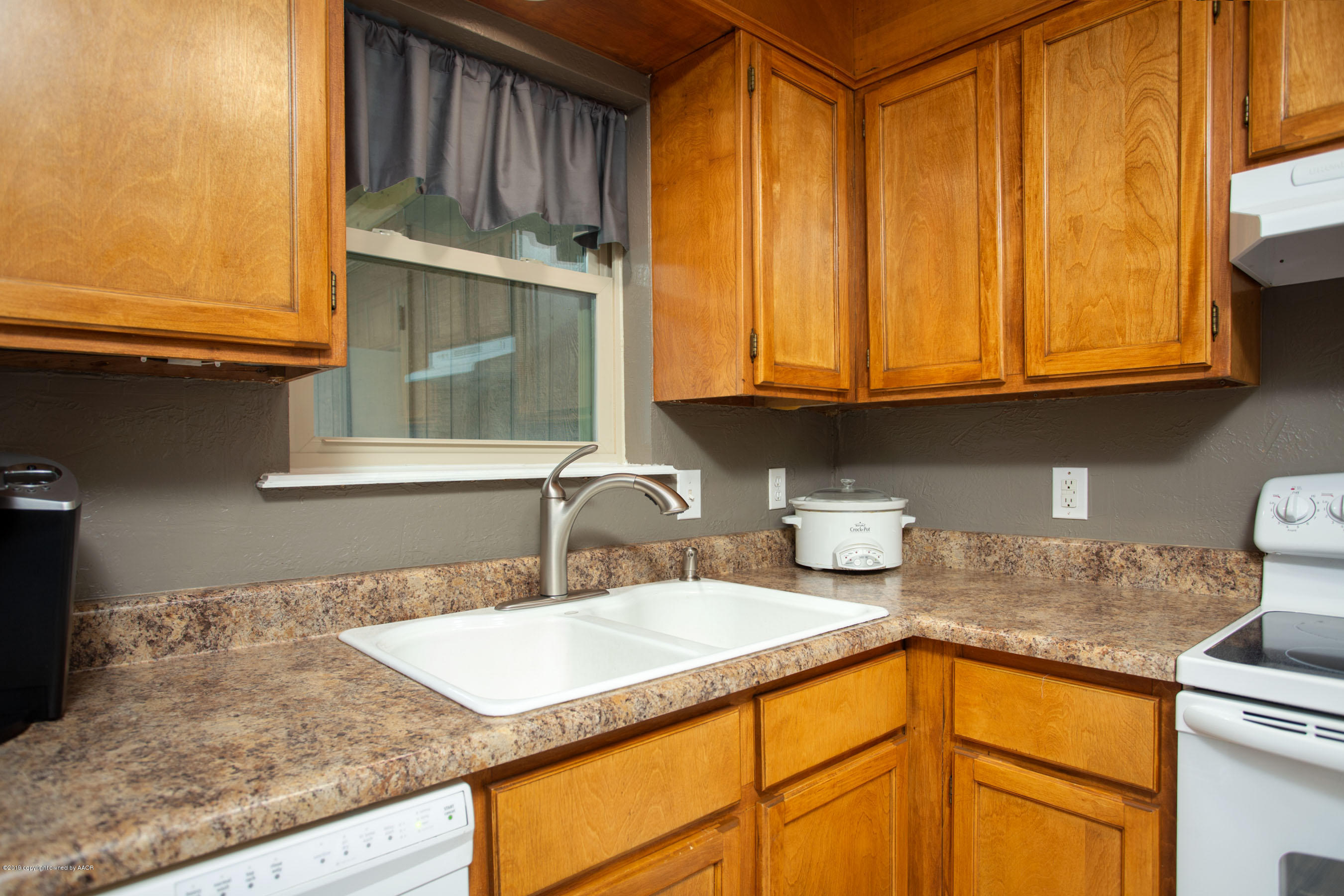 8110 Santa Fe Trail Amarillo, TX 79110 - Photo 10 of 25 a kitchen with stainless steel appliances granite countertop a sink and cabinets