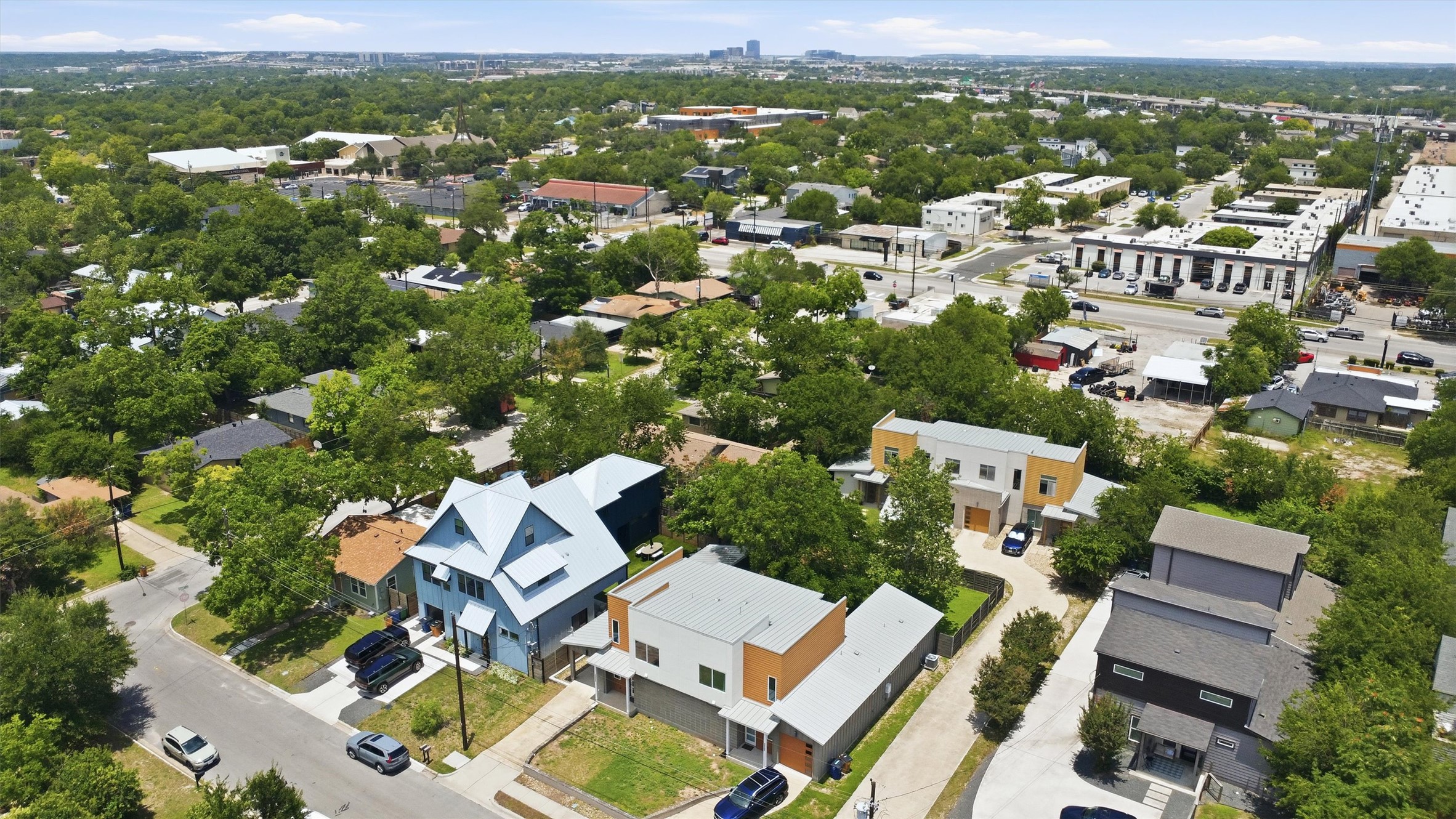 1210 Stobaugh Street, Unit B Austin, TX 78757 - Photo 36 of 40 An aerial perspective reveals a diverse urban landscape with residential and commercial properties nestled among abundant greenery.