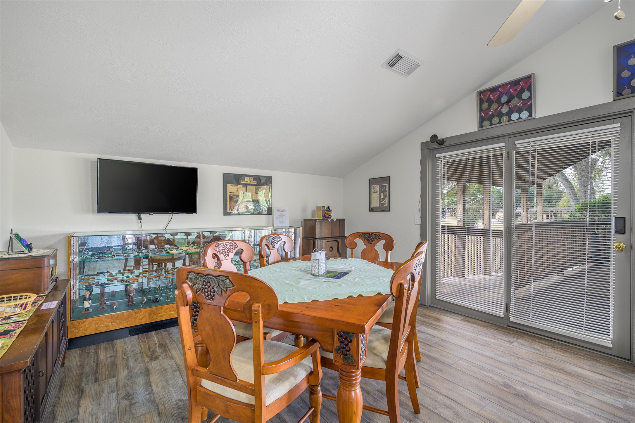 1441 Salem Road Brenham, TX 77833 - Photo 15 of 34 a view of a dining room with furniture wooden floor and flat screen tv