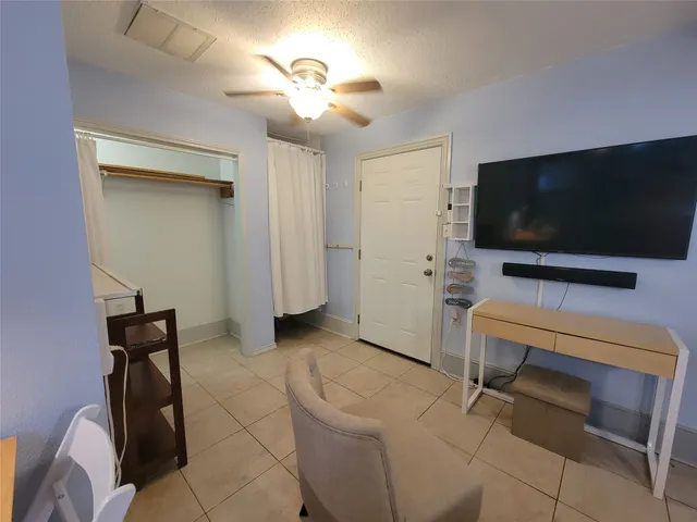 a living room with furniture a dining table and chairs