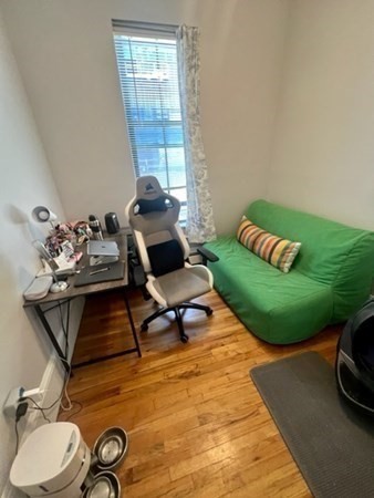 93 East Brookline Street, Unit 2 Boston, MA 02118 - Photo 4 of 8 a living room with a bed and a chair