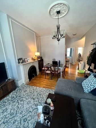 93 East Brookline Street, Unit 2 Boston, MA 02118 - Photo 7 of 8 a living room with furniture a rug and a chandelier
