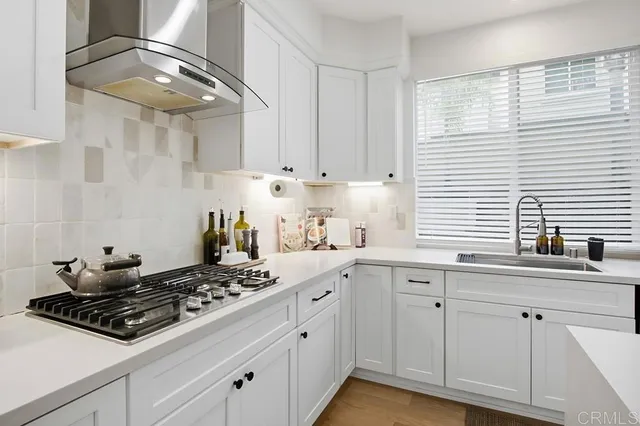 a large kitchen with a table and chairs