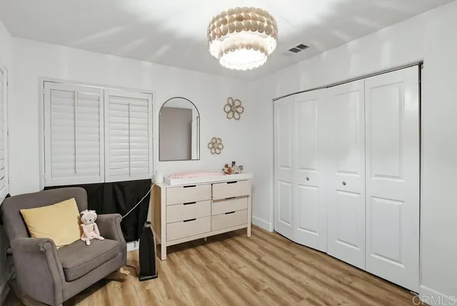 a hallway with white cabinets and washer