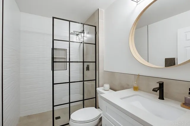 a view of a hallway with wooden floor and windows
