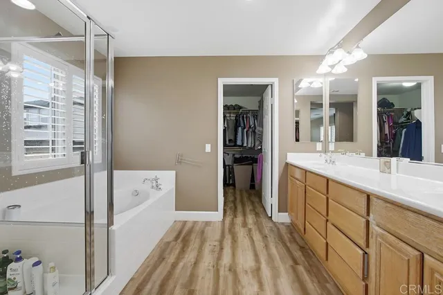 a bathroom with a tub shower and a sink