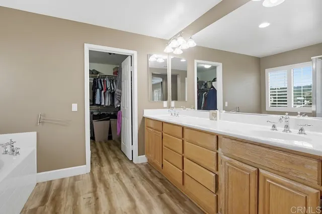 a view of walk in closet with clothes