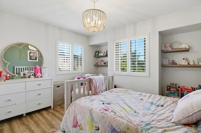 a bedroom with a bed and a painting on the wall