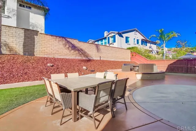 a view of a patio with table and chairs potted plants