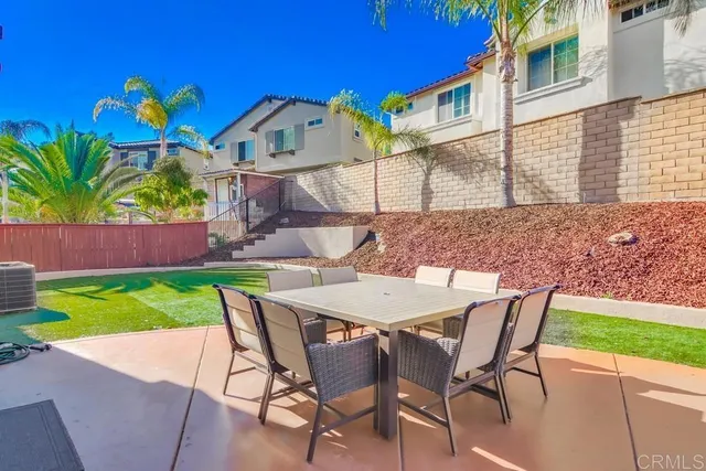 a view of an house with backyard porch and sitting area