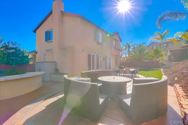 a view of a house with backyard porch and sitting area