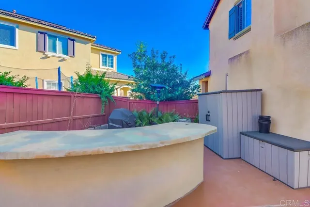 a view of backyard of house with outdoor seating and green space