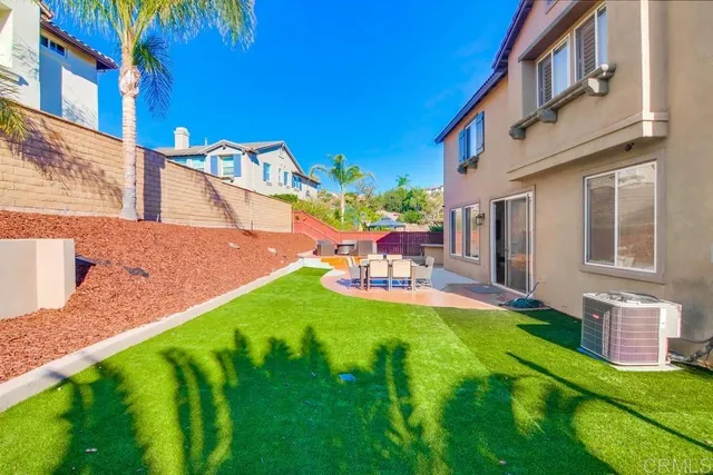 a view of a park with large trees and a small yard