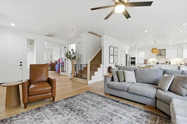 a living room with furniture and kitchen view