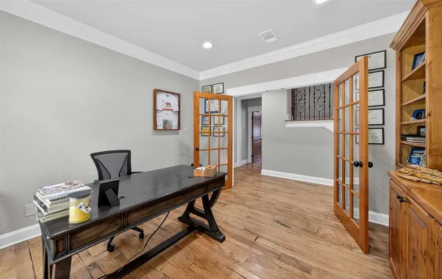 a view of a workspace with furniture and a window