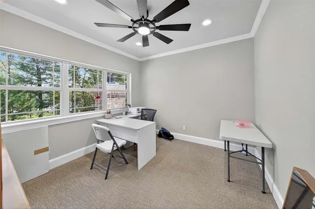 a view of a workspace with furniture and a window