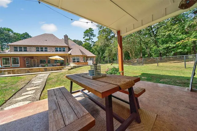 a view of a house with pool and a yard