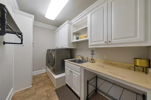 a view of a kitchen with sink and cabinets