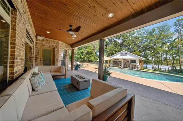 a living room with furniture and a floor to ceiling window
