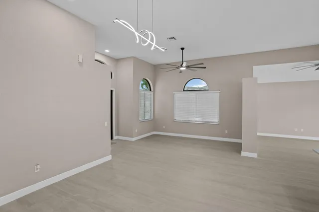 an empty room with a empty space and windows