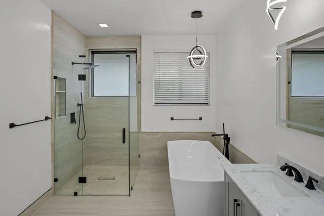 a bathroom with a shower a sink and a toilet