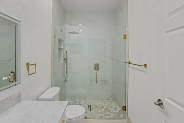 a bathroom with a toilet and shower