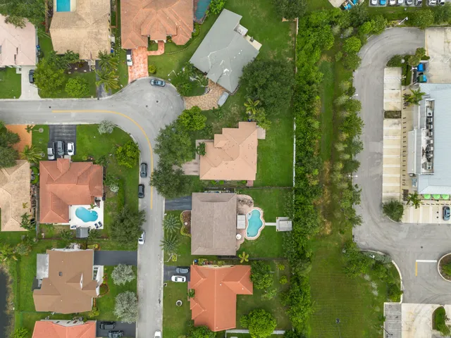 an aerial view of multiple houses with yard