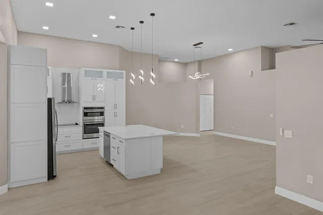 a view of a kitchen with refrigerator and a sink
