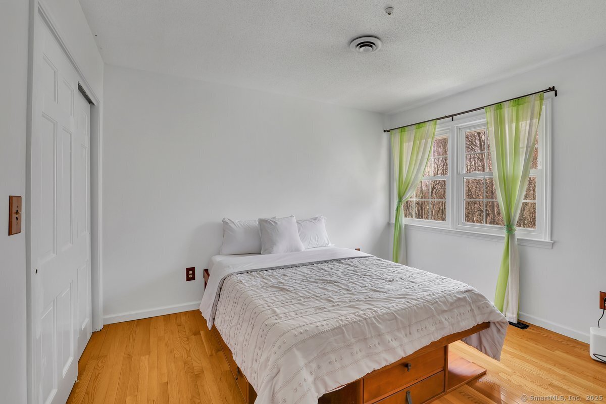 96 Neill Drive Watertown, CT 06795 - Photo 12 of 20 a bedroom with a bed and a window