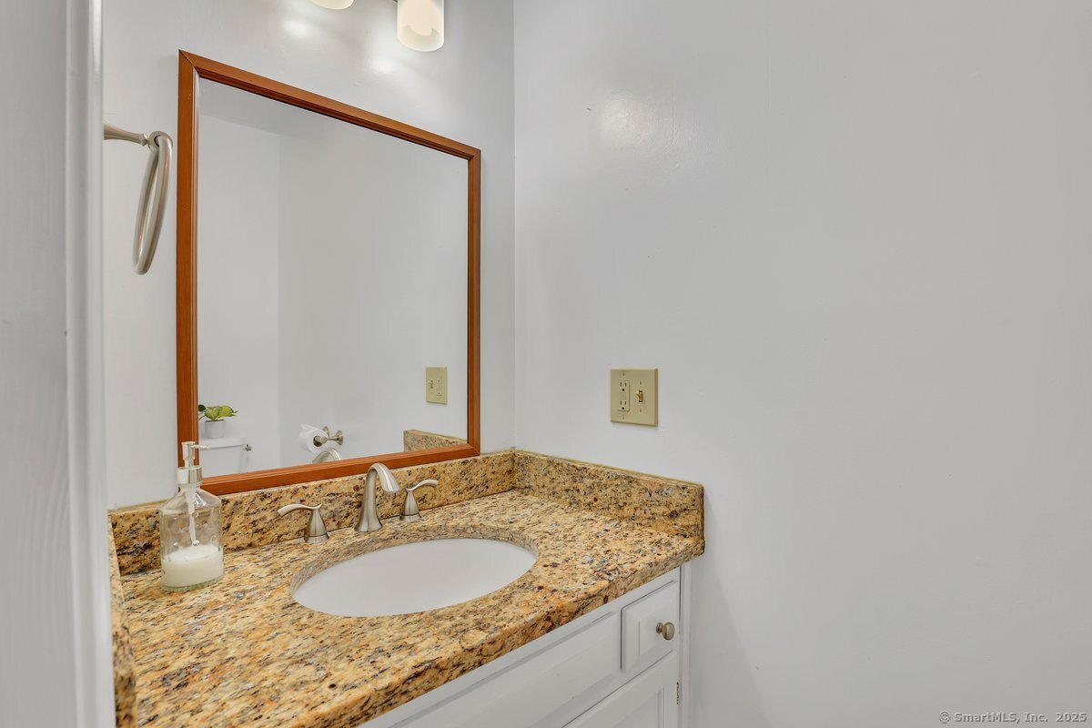 96 Neill Drive Watertown, CT 06795 - Photo 15 of 20 a bathroom with a granite countertop sink and a mirror