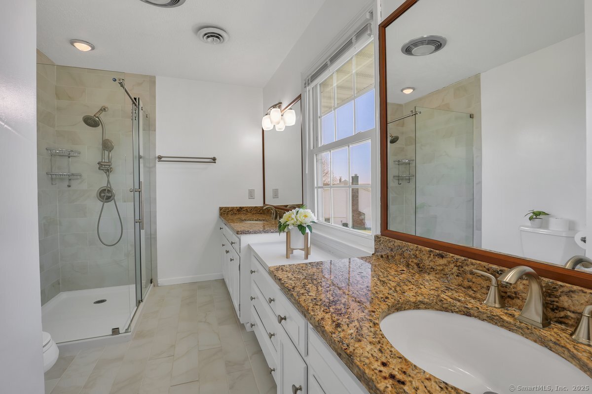 96 Neill Drive Watertown, CT 06795 - Photo 16 of 20 a bathroom with a granite countertop tub sink and mirror