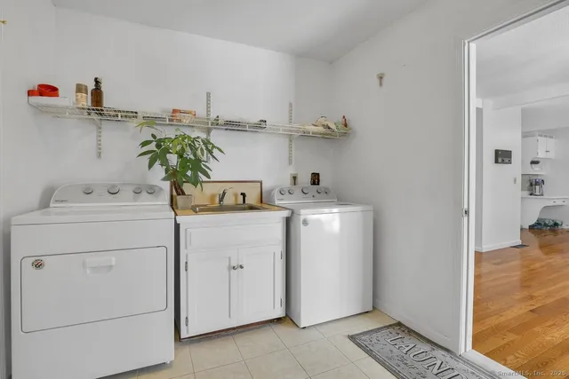 a utility room with cabinets washer and dryer
