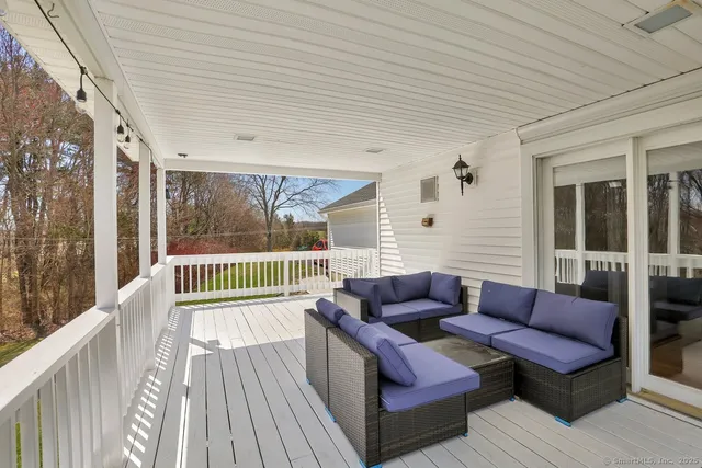a balcony with furniture and wooden floor