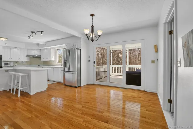 a view of a kitchen with stainless steel appliances granite countertop a refrigerator and a sink