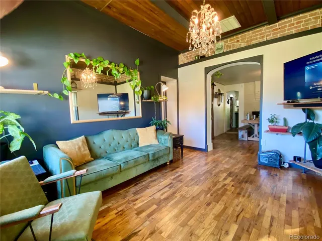a living room with furniture and a chandelier