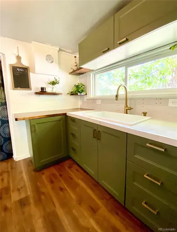 a kitchen with a sink and wooden cabinets